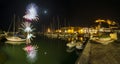 Italy, Tuscany Maremma Castiglione della Pescaia, fireworks over the sea, panoramic night view of the port and the castle Royalty Free Stock Photo
