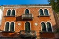 Italy, Venice, a bench in front of a brick building