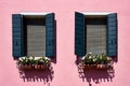Italy, Venice, Burano island. Traditional colorful walls and windows with green shutters of the old houses. Royalty Free Stock Photo