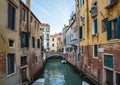 Italy, Venice, February 25, 2017. A street in Venice with boats, a bridge and tourists