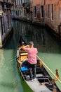 Italy, Venice, Gondolier navigating a gondola near San Moise on a canal