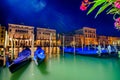 Italy Venice grand canal gondola pier row anchored overnight at sunset blurred illuminated at poles from sea water along ancient p Royalty Free Stock Photo