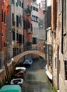 Italy- Venice- Narrow Residential Canal With Boats and Bridge Royalty Free Stock Photo