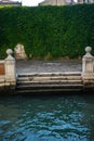 Italy, Venice, sitting bench in front of a building with plants on wall