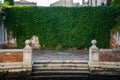Italy, Venice, sitting bench in front of a building with plants on wall
