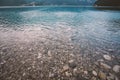 Italy view of the bottom of the beach mountain lake lago di ice in summer in cloudy weather Royalty Free Stock Photo