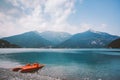 Italy view of a mountain lake lago di ledro with a beach and a lifeboat catamaran of red color in summer in cloudy weather Royalty Free Stock Photo