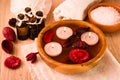 Items for spa treatments. Candles, essential oils, water, flowers, sea salt, and towels