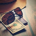 Items for summer vacation: a camera, passport,smartphone, money, hat, sunglasses. Wooden background, top view with Copy space. Royalty Free Stock Photo