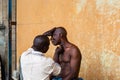 Itinerant barber under the Marina bridges Lagos Nigeria West Africa