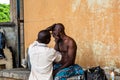 Itinerant barber under the Marina bridges Lagos Nigeria West Africa