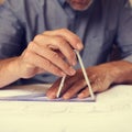 Its all about accuracy. a draftsman using a triangle and compass to draw up building plans. Royalty Free Stock Photo