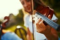 Its all about following the notes. a young girl playing a violin outdoors. Royalty Free Stock Photo