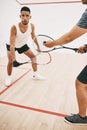 Its all in how you hit the ball. two young men playing a game of squash. Royalty Free Stock Photo