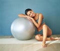 Its all about lifestyle change. a sporty young woman leaning against a pilates ball. Royalty Free Stock Photo