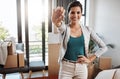 Its all mine. Cropped portrait of an attractive young woman holding the key to her new home while moving in. Royalty Free Stock Photo