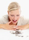 Its all mine. Shot of a beautiful woman looking at coins on the table in front of her. Royalty Free Stock Photo