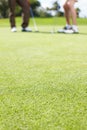 Its all about the perfect shot. Two men out on the green playing a round of golf together - cropped. Royalty Free Stock Photo