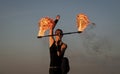 Its all about sparkles. Sexy woman twirl fire batons. Female fire performer on blue sky. Woman fakir perform solo