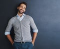 Its all about staying positive. Portrait of a handsome young businessman posing against a dark background. Royalty Free Stock Photo