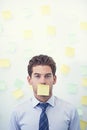 Its all sticky notes and no verbal communication. a young businessman with a sticky note over his mouth. Royalty Free Stock Photo