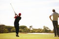 Its all in the swing. two handsome men playing a game of golf. Royalty Free Stock Photo