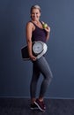 Its as easy as an apple a day. Studio portrait of an attractive mature woman holding an apple and a weightscale against Royalty Free Stock Photo