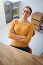 Its been a great day in the office. High angle portrait of a smiling young female designer sitting at her desk in an Royalty Free Stock Photo