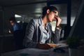 Its been a long day. Shot of a young attractive businesswoman working late at night in a modern office. Royalty Free Stock Photo