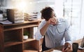 Its been a long and exhausting day. a young businessman looking exhausted while working late in an office. Royalty Free Stock Photo