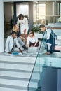 Its about being comfortable in your role. a group of coworkers working together while gathered on the floor. Royalty Free Stock Photo