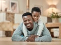 Its about being there for your kids. Full length portrait of a handsome young man and his son lying on the living room Royalty Free Stock Photo