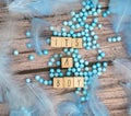 Its a boy text on wooden background texture with blue feathers for baby invitation shower or newborn, boy announcement