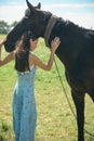 Its about building a trusting relationship. Adorable horse owner touching pet. Pretty girl at horse ranch. Making