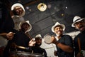 Its carnival time. Portrait of a group of musical performers playing drums together.