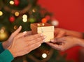 Its a Christmas eve tradition. two unrecognizable women exchanging gifts at Christmas. Royalty Free Stock Photo