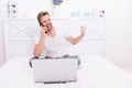 Its a deal. Happy man make winner gesture in bed. Phone conversation. Bet winner. Online betting Royalty Free Stock Photo