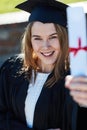 Its definitely my proudest moment. Portrait of a young student holding her diploma on graduation day. Royalty Free Stock Photo