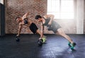 Its a display of absolute power. Full length shot of two young athletes working out in the gym.