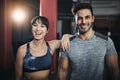 Its easy to keep our workouts fresh and enjoyable. a sporty young man and woman standing together in the gym. Royalty Free Stock Photo