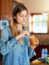 Its about enjoying the sweet things in life. a young woman eating peanut butter out of the jar with a spoon. Royalty Free Stock Photo