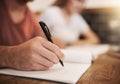 Its exam season. two unrecognizable students having a study session at a table in a cafe. Royalty Free Stock Photo