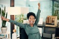 Its finally home-time. Portrait of a young businesswoman cheering while working in an office.