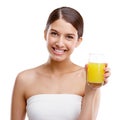 Its freshly squeezed. Studio portrait of an attractive young woman holding a glass of orange juice. Royalty Free Stock Photo