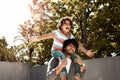 Its a fun day out. a father giving his little son a piggyback ride outdoors. Royalty Free Stock Photo