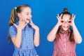 Its funny. Funny children. Funny little girls enjoy playing together. Small kids gesturing and making funny faces for Royalty Free Stock Photo