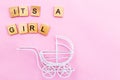 Its a girl. Little vintage white baby carriage stroller or pram on a pink background. Royalty Free Stock Photo