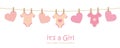 Its a girl welcome greeting card for childbirth with hanging hearts and bodysuits Royalty Free Stock Photo