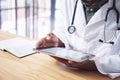 Its going to be a busy day in the clinic. an unrecognizable doctor sitting alone in his office at the clinic and using Royalty Free Stock Photo