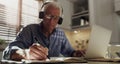 Its going to be a busy day. a senior man sitting alone in the kitchen and wearing a headset to work from home. Royalty Free Stock Photo